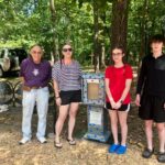 Youth and family installing Little Libary at Oak Grove's playground