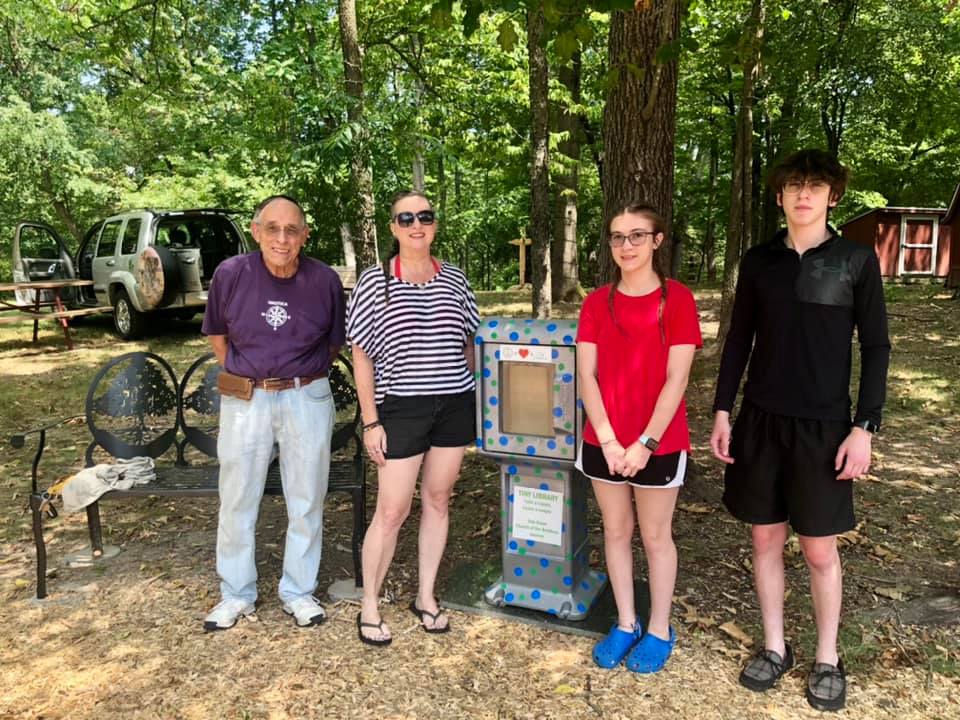 Youth and family installing Little Libary at Oak Grove's playground